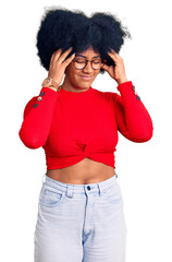 Canvas Print - Young african american girl wearing casual clothes and glasses with hand on head, headache because stress. suffering migraine.