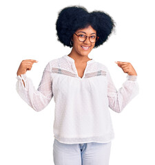 Poster - Young african american girl wearing casual clothes looking confident with smile on face, pointing oneself with fingers proud and happy.