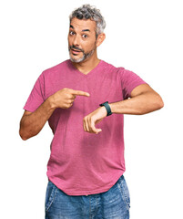 Wall Mural - Middle age grey-haired man wearing casual clothes in hurry pointing to watch time, impatience, upset and angry for deadline delay