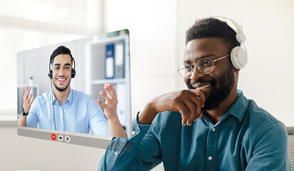 Aufkleber - Black businessman immersed in virtual meeting with colleague at office