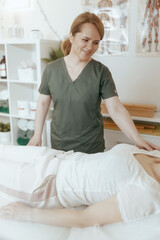 Poster - female therapist in massage cabinet conducting examination