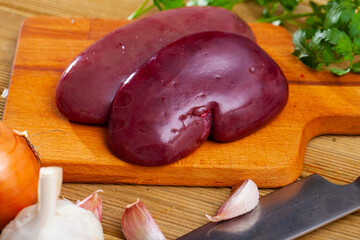 Wall Mural - Fresh raw pork kidneys with seasonings on wooden background. Home cooking