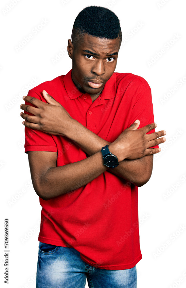 Young african american man wearing casual red t shirt shaking and freezing for winter cold with sad and shock expression on face