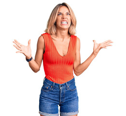 Wall Mural - Beautiful caucasian woman wearing casual clothes crazy and mad shouting and yelling with aggressive expression and arms raised. frustration concept.