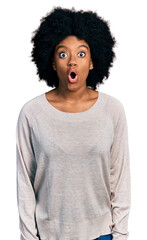 Canvas Print - Young african american woman wearing casual clothes afraid and shocked with surprise expression, fear and excited face.