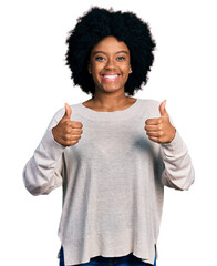 Wall Mural - Young african american woman wearing casual clothes success sign doing positive gesture with hand, thumbs up smiling and happy. cheerful expression and winner gesture.