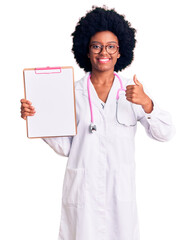 Poster - Young african american woman wearing doctor stethoscope holding clipboard smiling happy and positive, thumb up doing excellent and approval sign