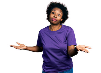 Sticker - African american woman with afro hair wearing casual purple t shirt clueless and confused expression with arms and hands raised. doubt concept.