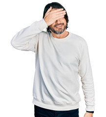 Poster - Middle age caucasian man wearing casual clothes covering eyes with hand, looking serious and sad. sightless, hiding and rejection concept