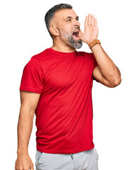 Wall Mural - Middle age handsome man wearing casual clothes shouting and screaming loud to side with hand on mouth. communication concept.