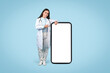 © Prostock-studio - Smiling female doctor pointing to mobile health app screen