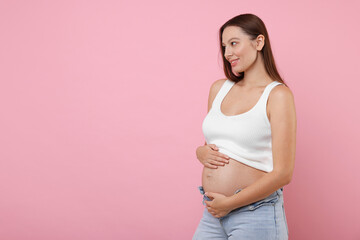 Canvas Print - Beautiful pregnant woman with long hair on pink background, space for text