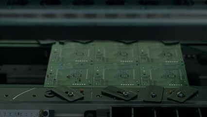 Poster - Coating machine for printed circuit board at work. Creative. Close up of automated robotic mechanism making circuit board.