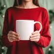 © crazyass - Girl in a red sweater holding a white mug.