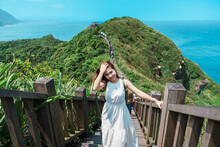 Woman Traveler Visiting In Taiwan, Tourist With Backpack Sightseeing In Bitou Cape Hiking Trail, New Taipei City. Landmark And Popular Attractions Near Taipei. Asia Travel Concept