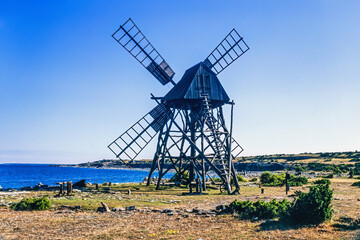 Poster - Old wooden windmill by the sea at Öland in sweden