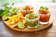assorted salsas with nachos, lime wedges, and cilantro, festive presentation