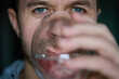 Man drinks water, Close-up shot of bearded man drinking fresh clean water from glass, Quenching thirst, Lifestyle healthcare concept