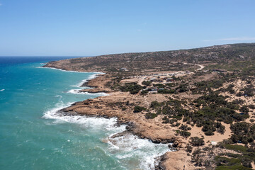 Wall Mural - Crete, Greece, Gavdos island. Aerial drone view of ripple sea water splashing the beach, nature.