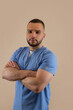 © RomanR - Portrait of young caucasian man doctor in blue uniform isolated, studio shoot