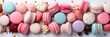 Colorful french desserts with sweets, top view, flat lay. Cake macaroons on plain background, colorful almond cookies, pastel colors. Banner. Flat lay, top view