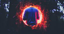 Man Walking In Front Of A Large Round Hole With Red Lights Coming From It
