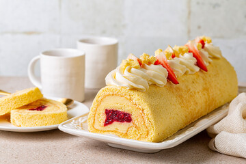 Poster - Rolled sponge cake filled with custard cream and berry jelly, decorated with whipped cream cheese and strawberries. Swiss or jelly roll cake, roulade or Swiss log. White background.