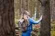 © Westend61 - Happy woman touching tree trunk in Cannock chase forest