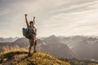 © Westend61 - Young man standing on mountain top with arms raised in Tannheimer Tal, Tyrol, Austria