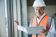 © Westend61 - Smiling senior engineer using tablet PC near window