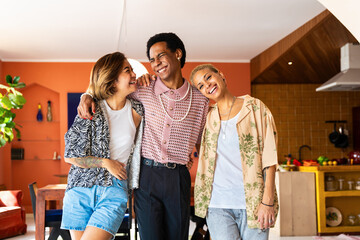 Wall Mural - Group of friends bonding at home, LGBTQ and diversity concepts - Homosexual couple and fluid gender non binary young man with LGBT cross dressing clothing style having fun in the apartment