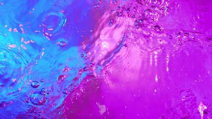 Canvas Print - Super slow motion of splashing water illuminated by neon lights. Filmed on high speed cinema camera, 1000 fps.