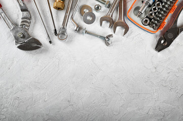 Set of hand tools on white plaster background. Work tools for carpenter, mechanic, plumber and hobist. Top view, space for text, flat lay.