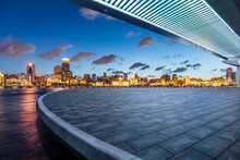 Empty Square Floor And Pedestrian Bridge With City Skyline At Night In Shanghai