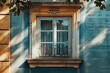 A picture of a blue building with a window and a balcony. Can be used for architectural designs or real estate concepts