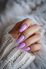 Poster - A close-up shot of a woman's hand holding a perfectly manicured purple nail. This image can be used in beauty and fashion-related projects