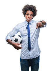 Sticker - Afro american manager man holding soccer ball over isolated background pointing with finger to the camera and to you, hand sign, positive and confident gesture from the front