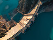 © ADDICTIVE STOCK - Top view of a massive dam structure with a reservoir in the mountains during clear weather