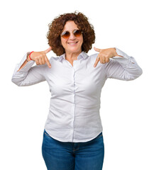 Sticker - Beautiful middle ager senior business woman wearing sunglasses over isolated background looking confident with smile on face, pointing oneself with fingers proud and happy.