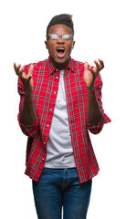 Wall Mural - Young african american man over isolated background crazy and mad shouting and yelling with aggressive expression and arms raised. Frustration concept.