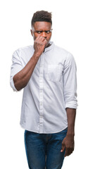 Wall Mural - Young african american man over isolated background looking stressed and nervous with hands on mouth biting nails. Anxiety problem.