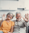 Sixty years couple, elderly parents communicates with grown up children using modern technologies makes video call, wave hands gesture of hello or goodbye sign, older generation and internet concept.