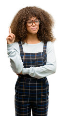 Sticker - African american woman wearing a retro style surprised with an idea or question pointing finger with happy face, number one