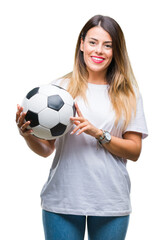 Canvas Print - Young beautiful woman holding soccer ball over isolated background with a happy face standing and smiling with a confident smile showing teeth