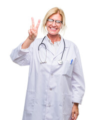 Sticker - Middle age blonde doctor woman over isolated background showing and pointing up with fingers number two while smiling confident and happy.