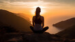 © Atthawut - Silhouette female YOGA sitting top cliff