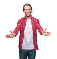 Sticker - Young handsome man with long hair wearing glasses over isolated background looking at the camera smiling with open arms for hug. Cheerful expression embracing happiness.