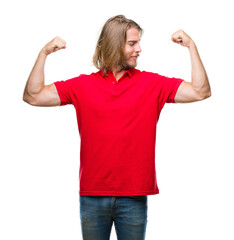 Sticker - Young handsome man with long hair over isolated background showing arms muscles smiling proud. Fitness concept.