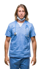 Poster - Young handsome doctor man with long hair over isolated background depressed and worry for distress, crying angry and afraid. Sad expression.