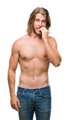 Poster - Young handsome shirtless man with long hair showing sexy body over isolated background looking stressed and nervous with hands on mouth biting nails. Anxiety problem.